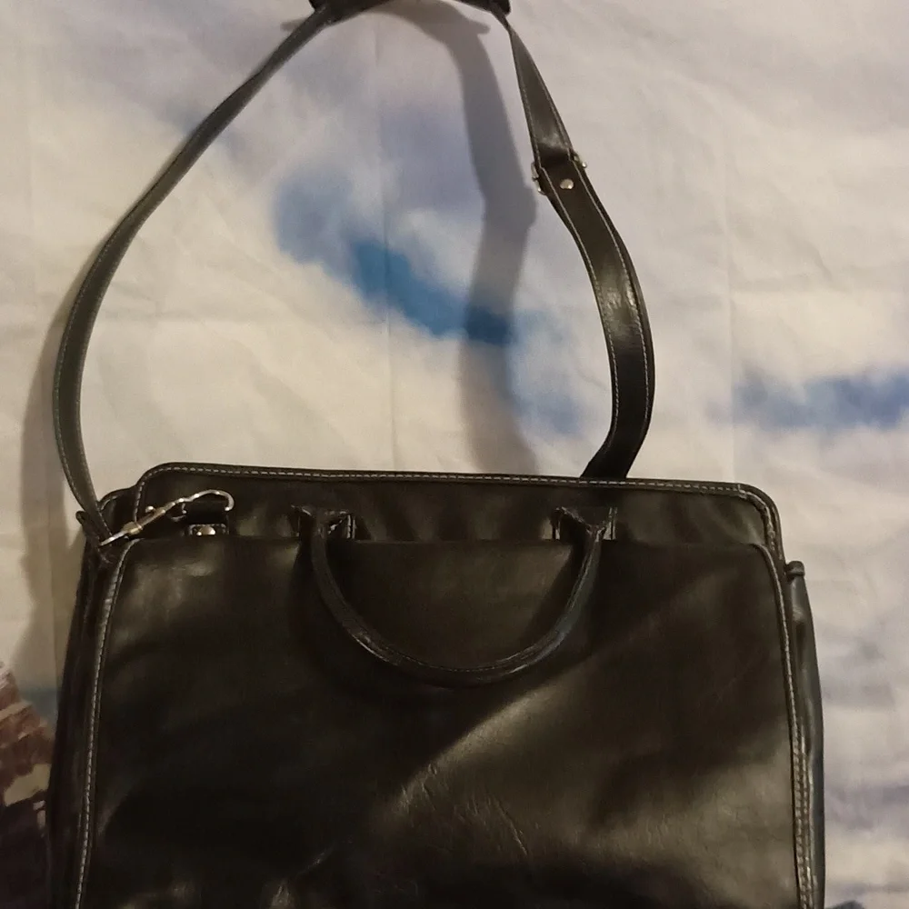 Global New Beginnings Leather laptop bag with pockets. Black bag includes strap